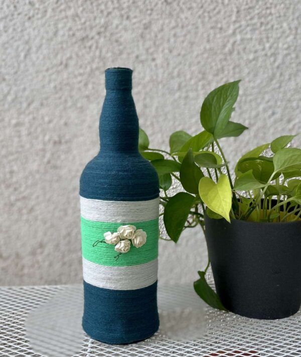 Hand-crafted-yarn-bottle-vase-dull-blue-white-flowers