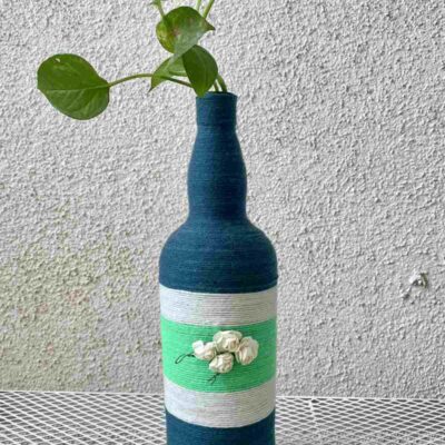 Hand-crafted-yarn-bottle-vase-dull-blue-white-flowers