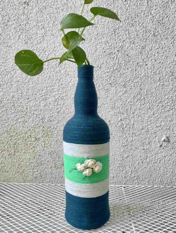 Hand-crafted-yarn-bottle-vase-dull-blue-white-flowers