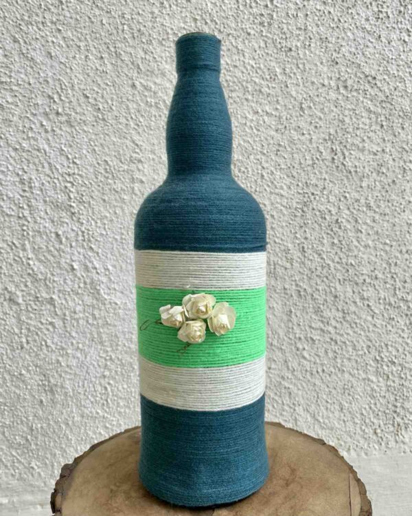 Hand-crafted-yarn-bottle-vase-dull-blue-white-flowers