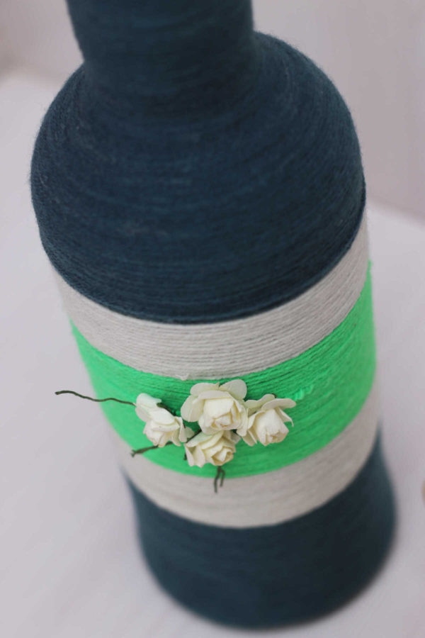 Hand-crafted-yarn-bottle-vase-dull-blue-white-flowers